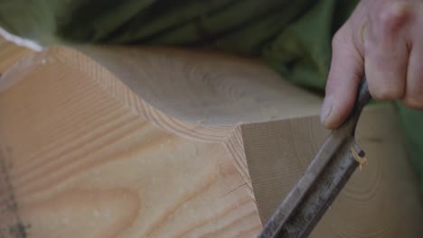 close up shot of worker cutting wood carefully, wood artisan work