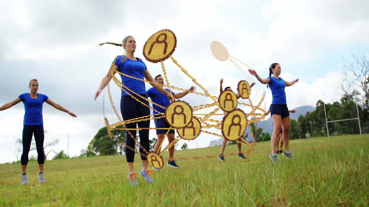 Fitness team performing jumping jacks on grass field, featuring floating gold network nodes overlay