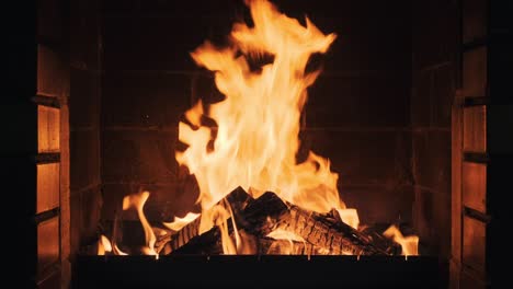 fire in the fireplace in lobby of large resort hotel in mountains slow motion. dry burning firewood in fireplace. pattern of bright orange flame. relax. family holidays