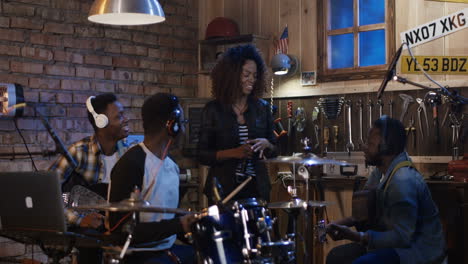 diverse band rehearsing in home studio