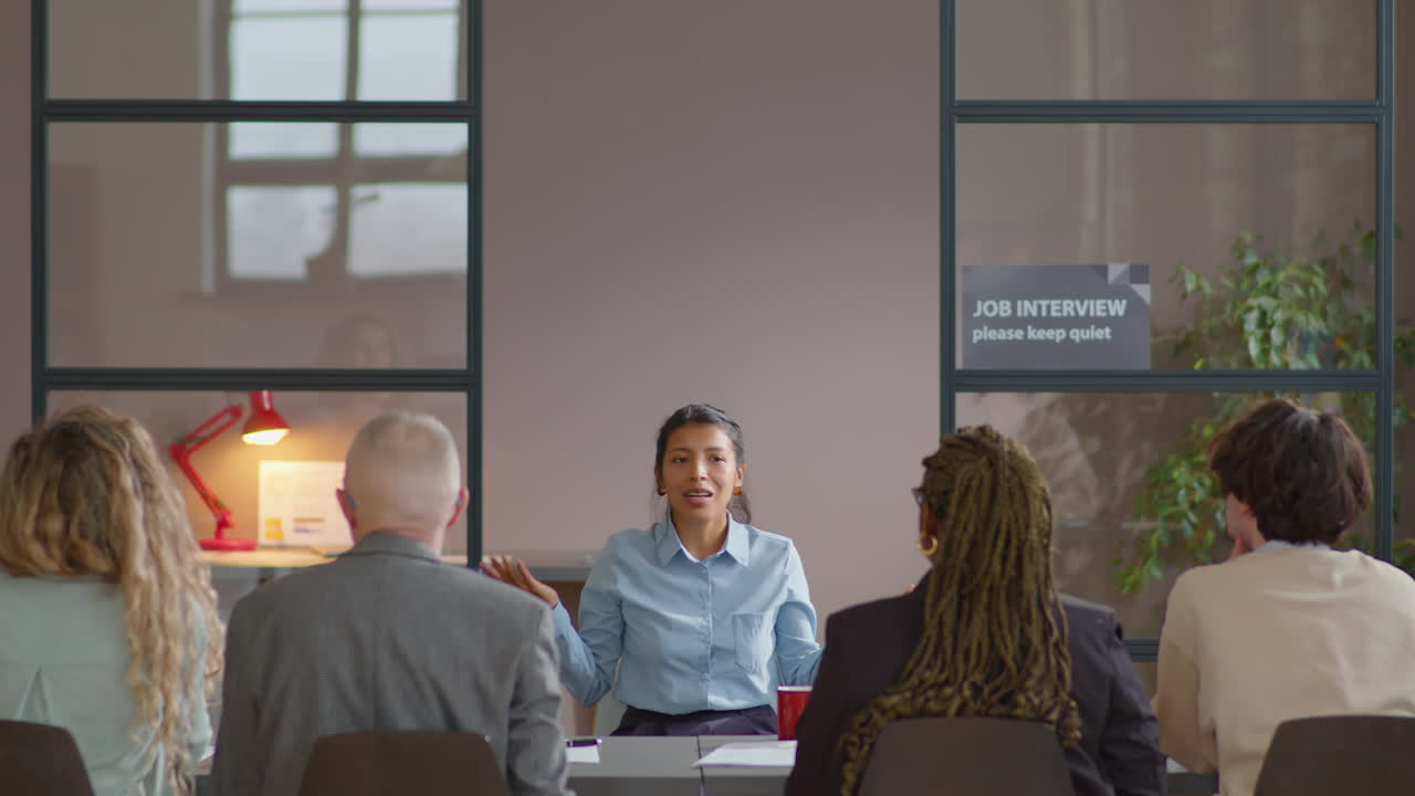 Hispanic Businesswoman Giving Self-Presentation to Hiring Committee