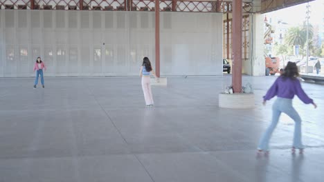 roller skaters in an empty warehouse