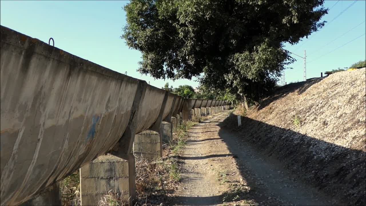 Elevated Concrete irrigation canal dropping down a level in countryside in Andalucía