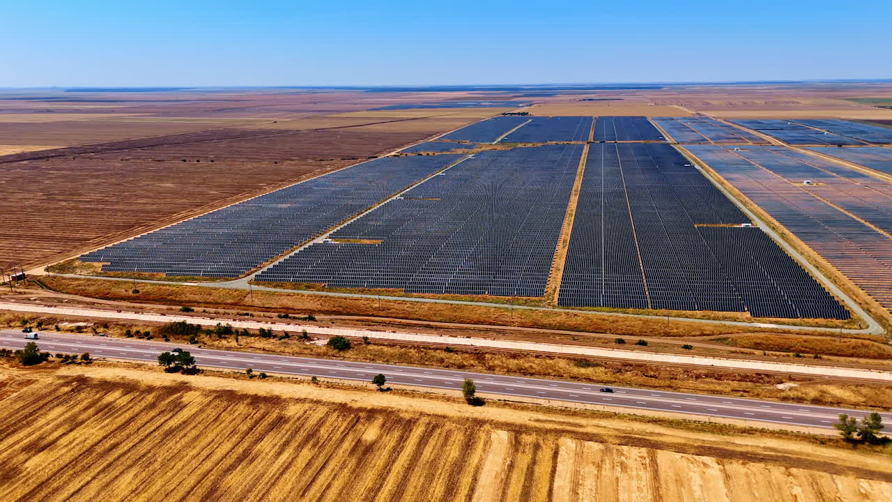 Summer solar farm in rural area. Solar panels blanket a rural area under a clear sky, showcasing renewable energy in agriculture