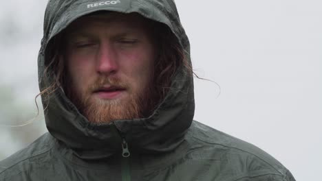 close-up portrait of a norwegian guy wearing a hooded winter jacket