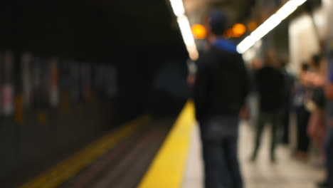 commuters waiting for train on subway platform 4k