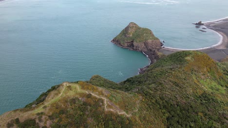 Paratutae-Island-With-Ninepin-Rock-At-Whatipu-Beach-In-Auckland,-New-Zealand---Drone-Shot