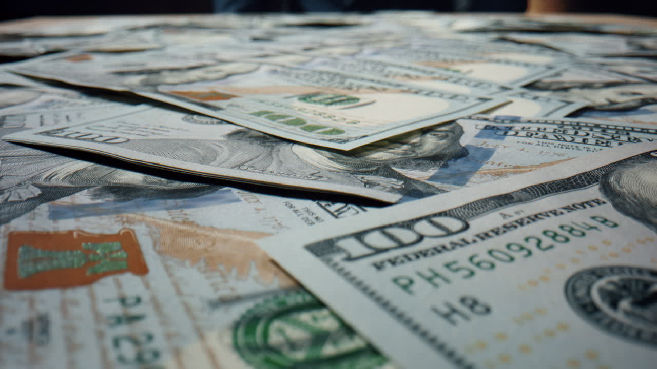 Hundred dollars falling table close up. Bills american currency scattering.