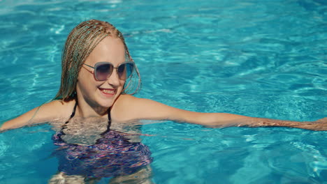 portrait of a child in the pool, looking into the camera, smiling