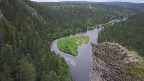 high angle view of a river winding through a lush forest