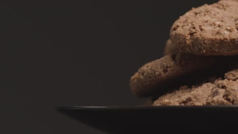 Close-Up-Shot-of-a-Plate-of-Chocolate-Cookies-Rotating-