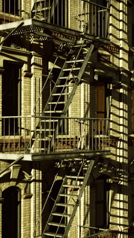 view of urban architecture with fire escape at sunset in a busy city