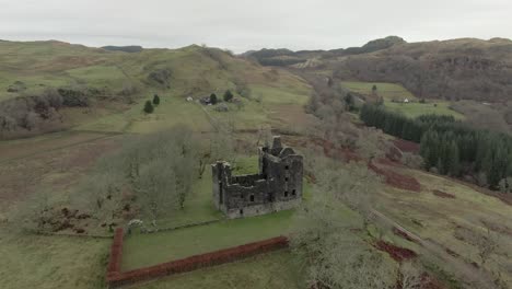 aerial view of carnasserie castle ruins on an overcast day in argyll and bute, scotland