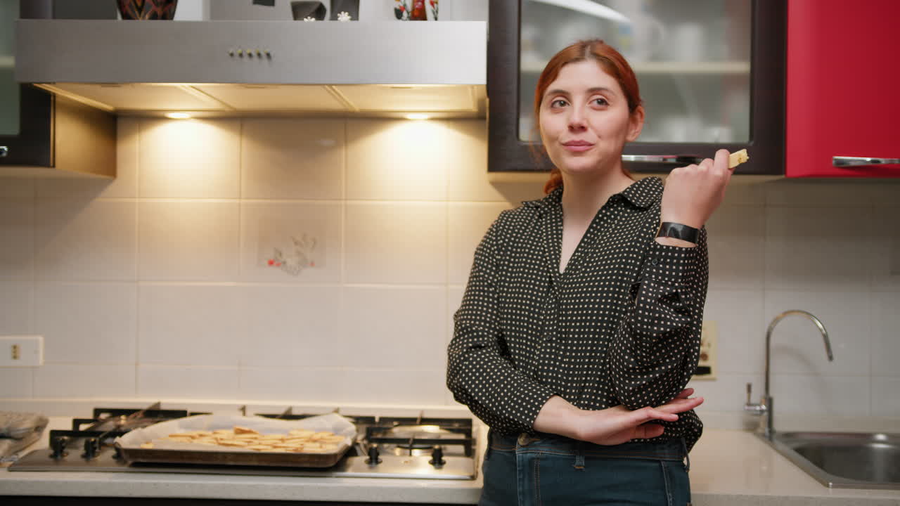 Woman Tastes A Cookie While Baking Desserts In The Kitchen