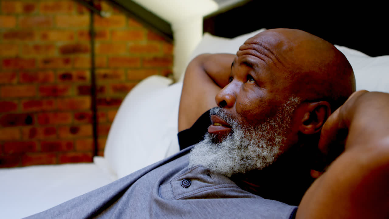 Senior man relaxing in bedroom at home 4k