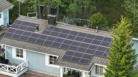 photovoltaic modules on a chouse roof, sunny day - telezoom, drone shot