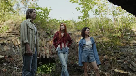 friends exploring a ruined area in the woods