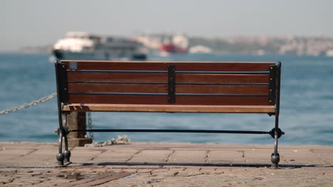 empty wooden bench by the water