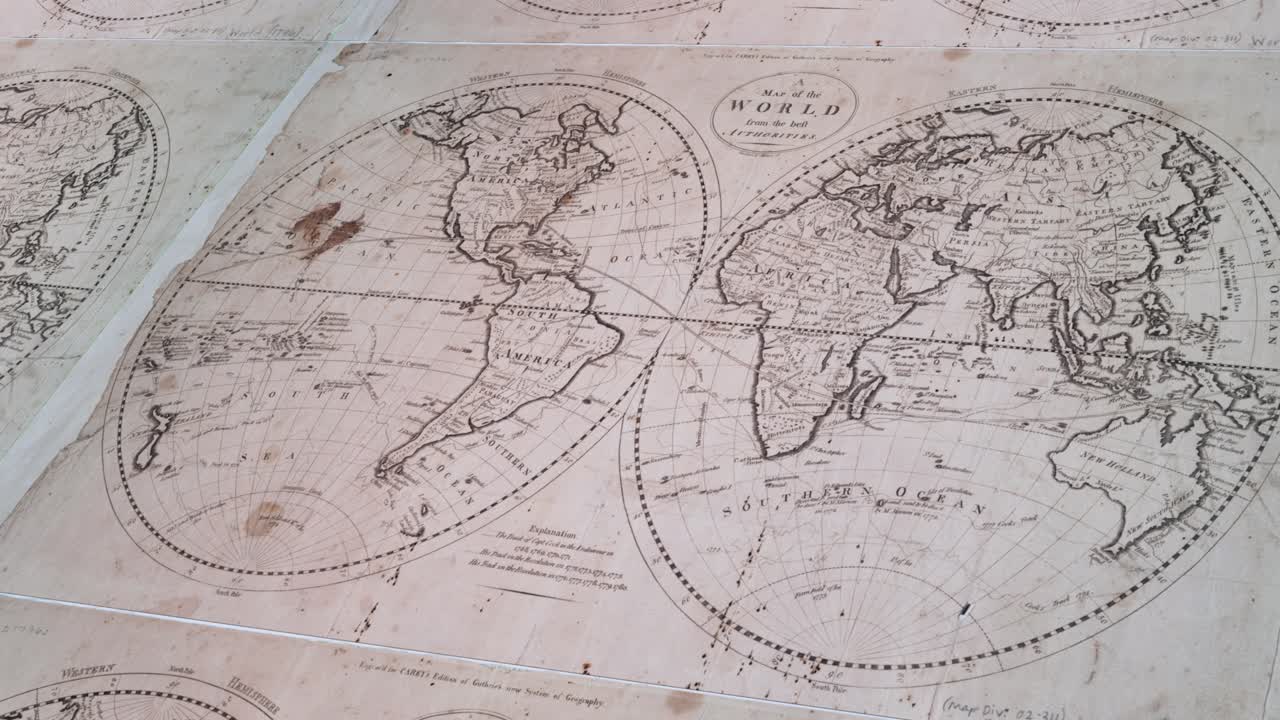 Historical map of the globe with visible creases and stains