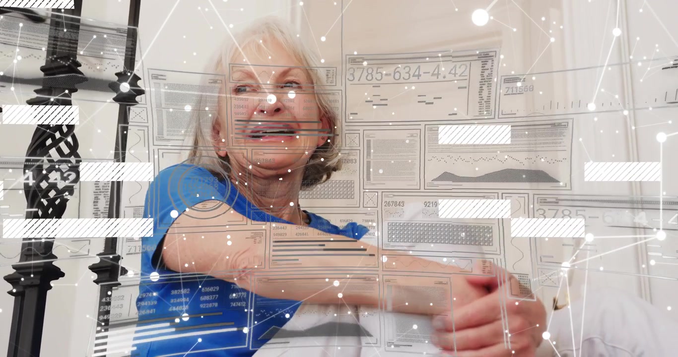 Senior woman hugging knees on floor, network overlay appearing and illustrating tech connectivity