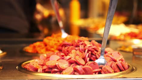 sliced pink sausages at a food stall