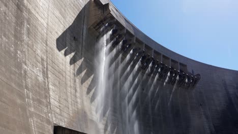 Water-falls-like-rain-from-flood-gates-atop-hydro-electric-dam-wall