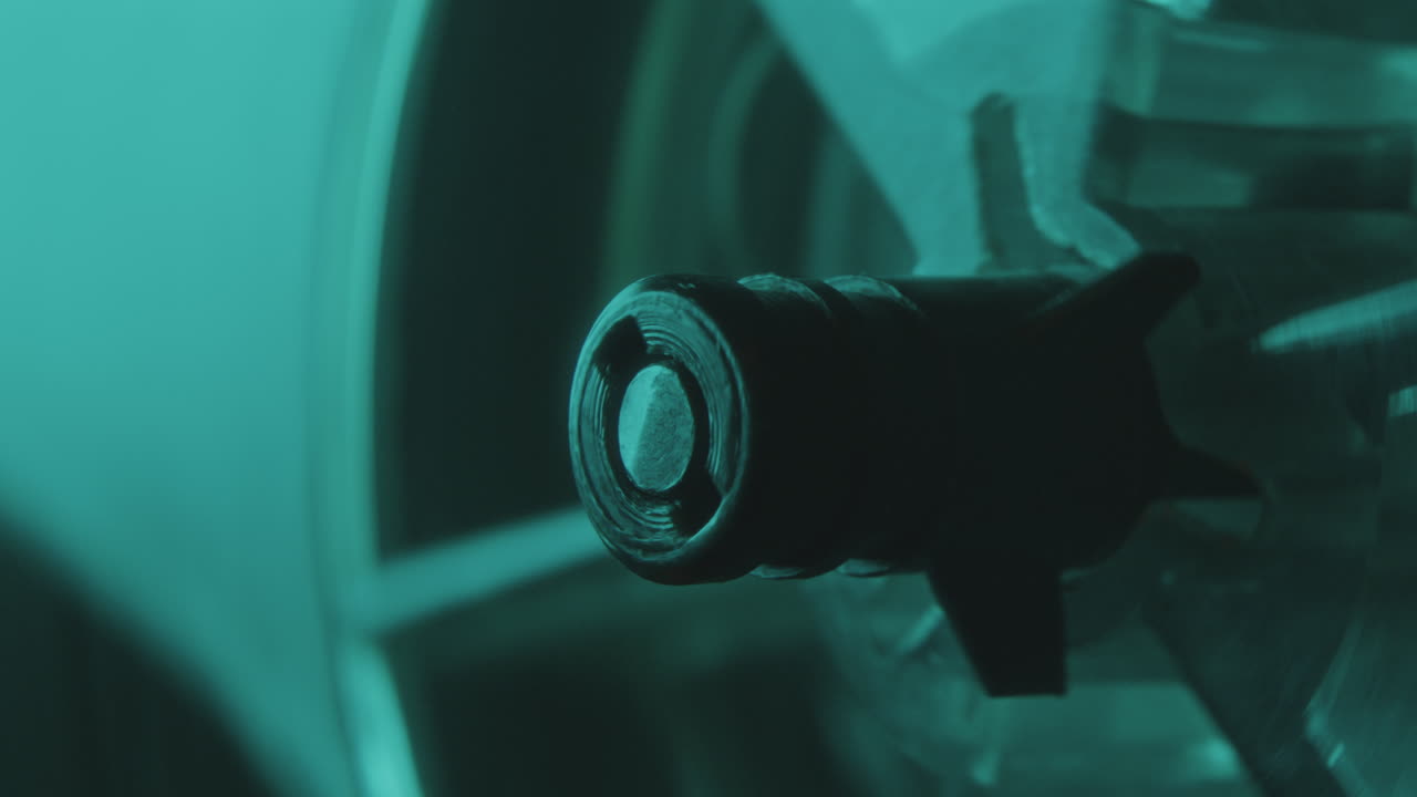 Extreme Close-Up of Reel Spindle Spinning as Playing Music