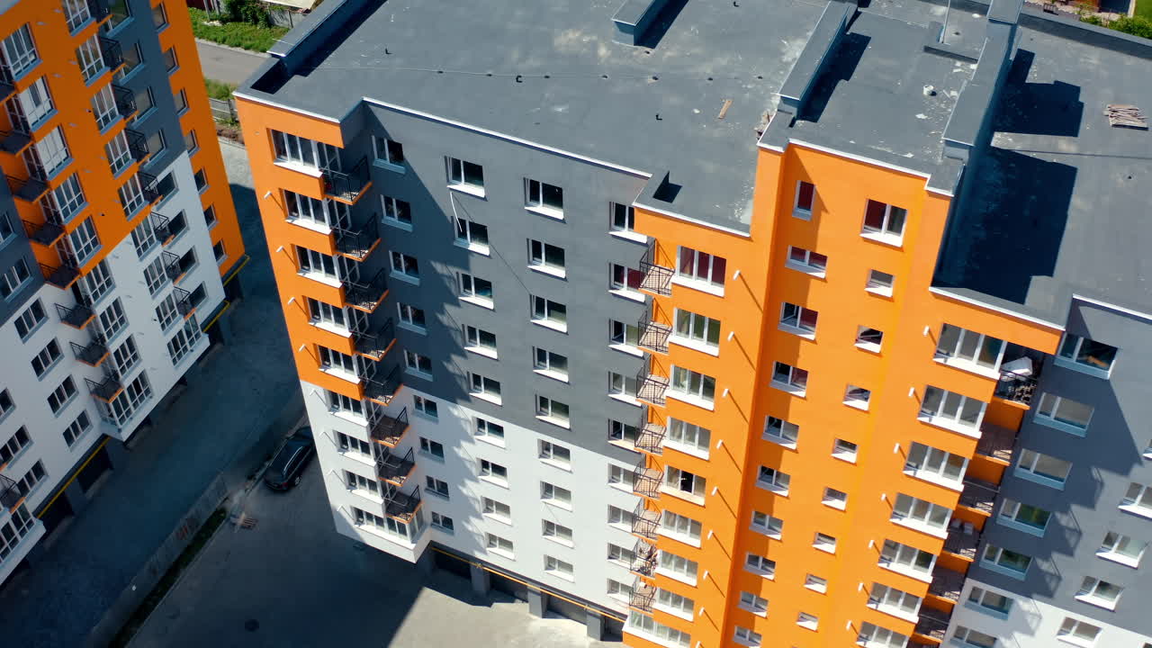 Apartment buildings with colorful walls. Modern residential apartments. Newly built block of flats for city residents. View from above.