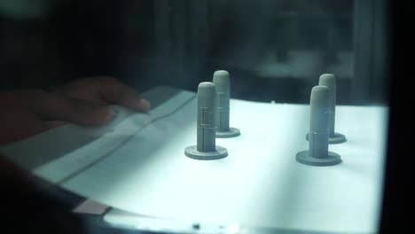 female hands moving 3d prints from 3d printer, real time