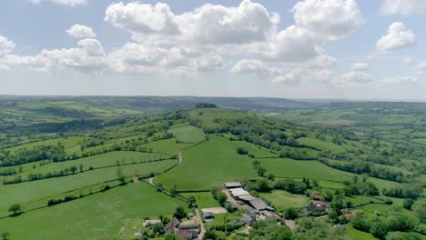 picturesque aerial of solitary countryside hill in the rolling devon landscape