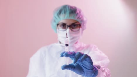 nurse holding an injection needles on hand wearing gloves standing on a hospital room with infection people from coronavirus