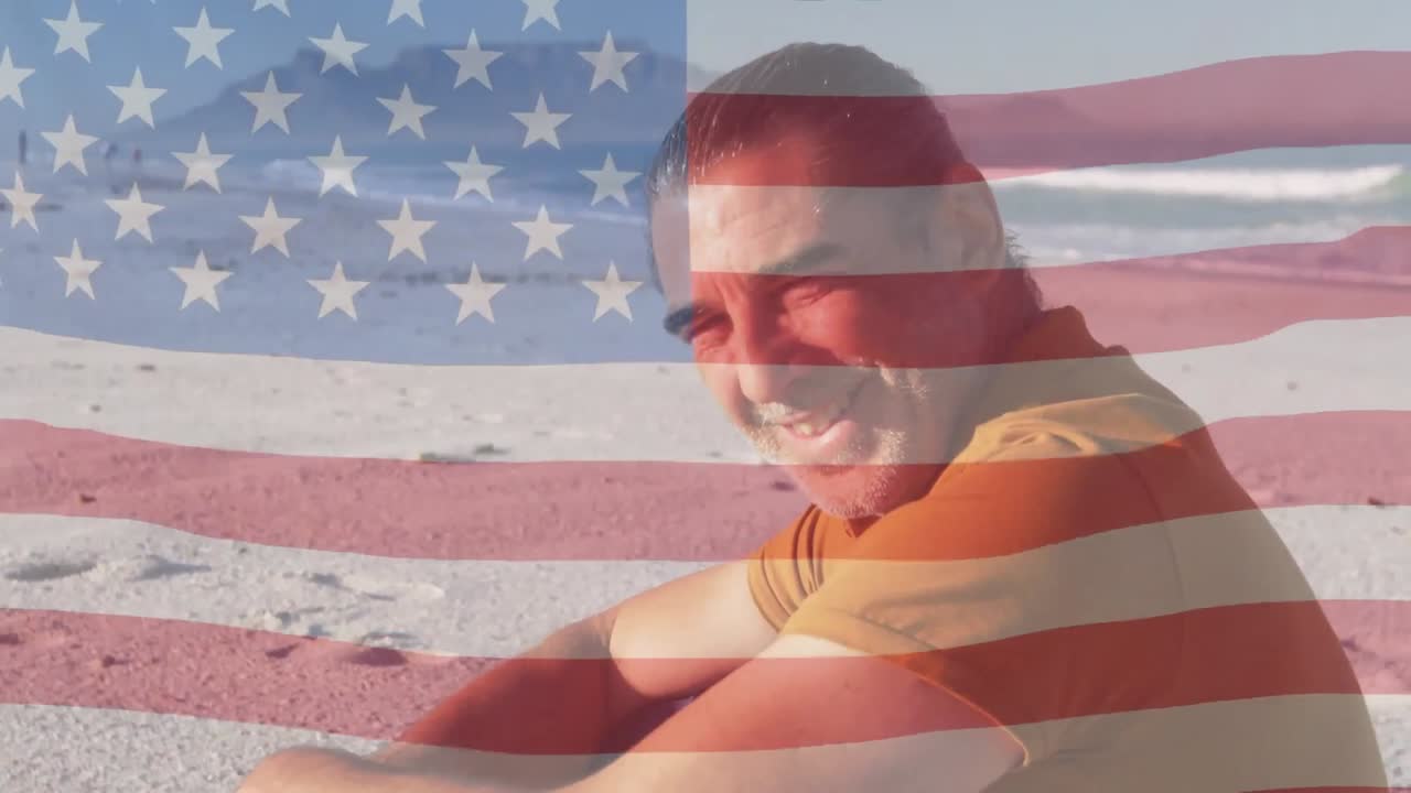 Animation of flag of usa over smiling caucasian man on beach