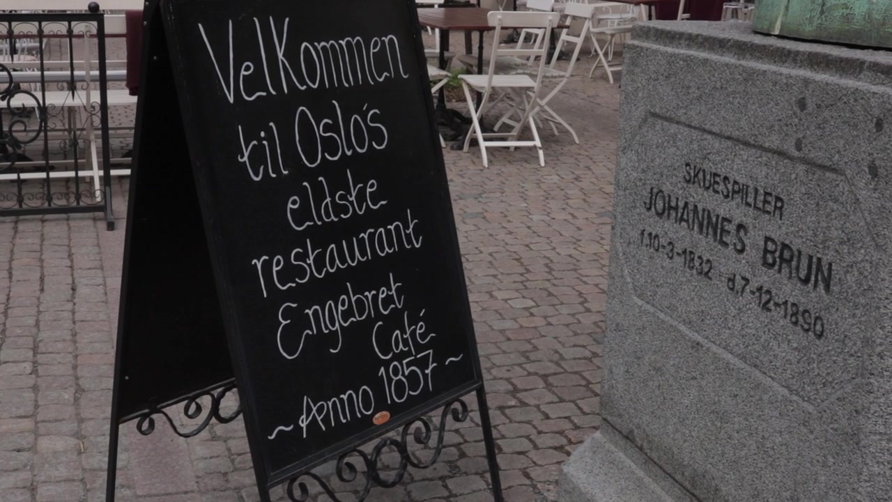 Kridttavleskilt for Oslos ældste restaurant på en brostensbelagt plads