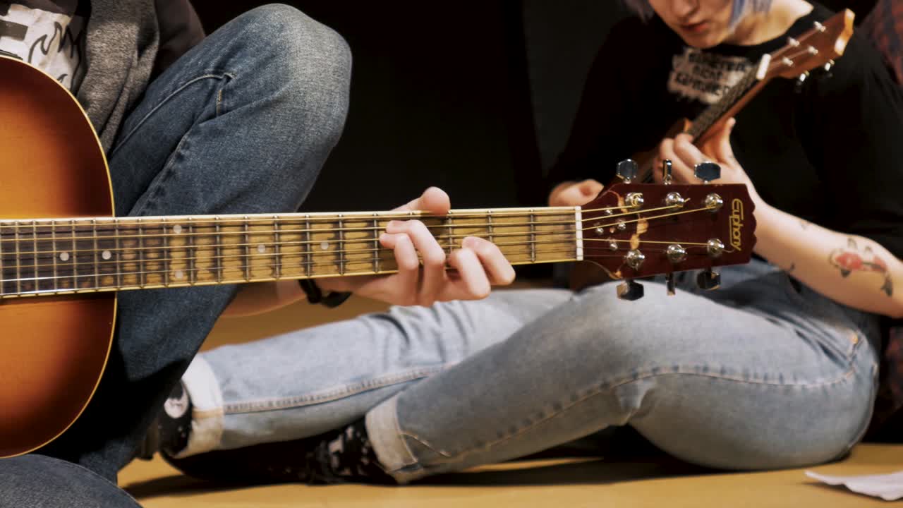 Young Musicians Playing Acoustic Guitar and Ukulele