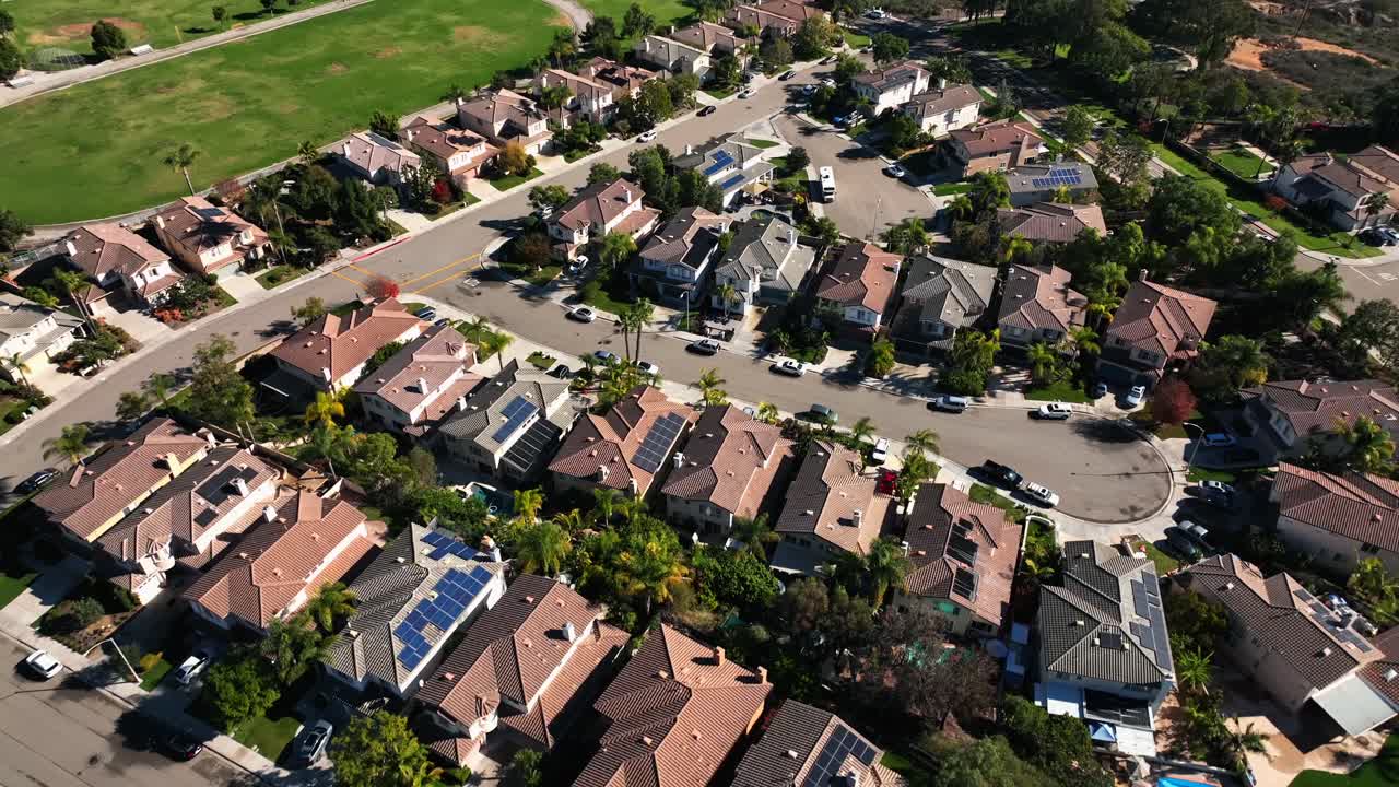 Slow-motion aerial drone cinematic view of the homes near the Calavera Hills on a sunny day in Carlsbad California - the coastal community in San Diego California