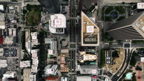 Aerial-top-shot-rising-above-skyscrapers-in-Los-Angeles-city,-California,-USA