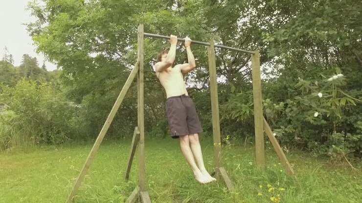 Close-grip chin-ups young athletic man working out on home gym