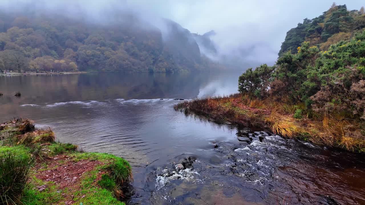 Glendalough Wicklow Ireland small stream draining The Upper Lake in a dramatic misty winter afternoon Ireland Epic Locations
