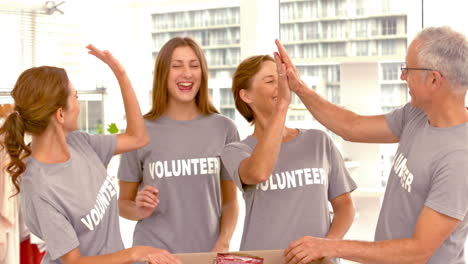 group of volunteers doing high fives