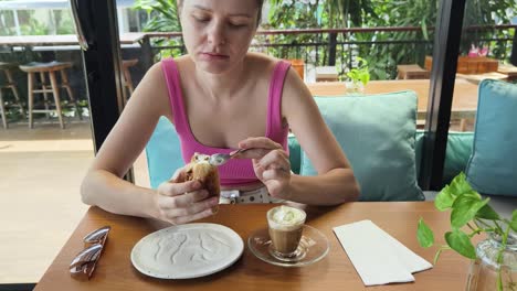 woman enjoying coffee and pastry in a cafe