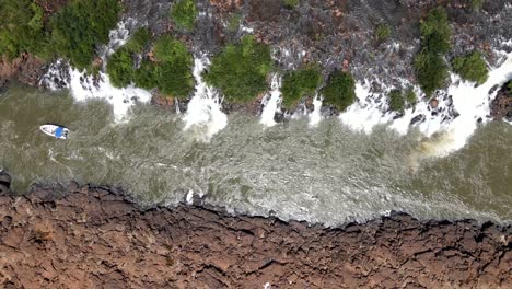 Top-View-over-the-Moconá-Waterfalls,-Boat-Following-the-Direction-of-the-River