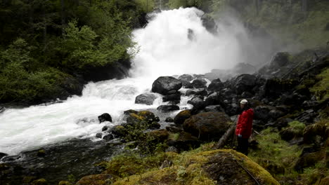 panning shot of tourist hiking through the rainforest to cascade creek waterfall in thomas bay southeast alaska