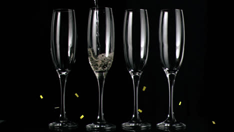 Animation-of-gold-confetti-falling-over-chmpagne-glasses-on-black-background