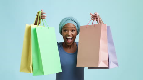 excited woman holding shopping bags