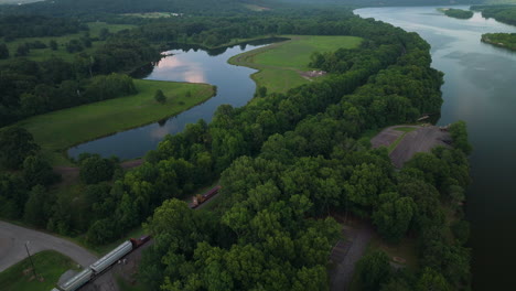 moving train on railway passing by scenic landscape of spadra park, arkansas