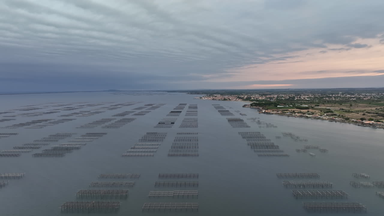 Etang de Thau, seen from above, displays oyster farms against the backdrop of a