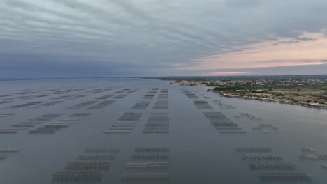 Etang-de-Thau,-seen-from-above,-displays-oyster-farms-against-the-backdrop-of-a