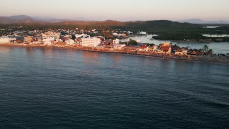 Drone-Revela-Barra-De-Navidad-En-La-Costa-Del-Pacífico-De-Jalisco,-México,-Al-Atardecer,-Surf-Town