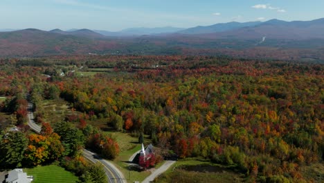 aerial view of a church surrounded with fall foliage in new hampshire