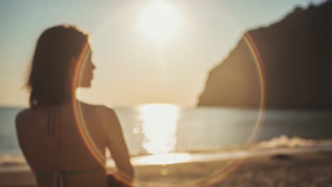 a serene sunset by the beach: a woman contemplating life's beauty as the golden sun sets over the tranquil ocean waves and sandy shoreline